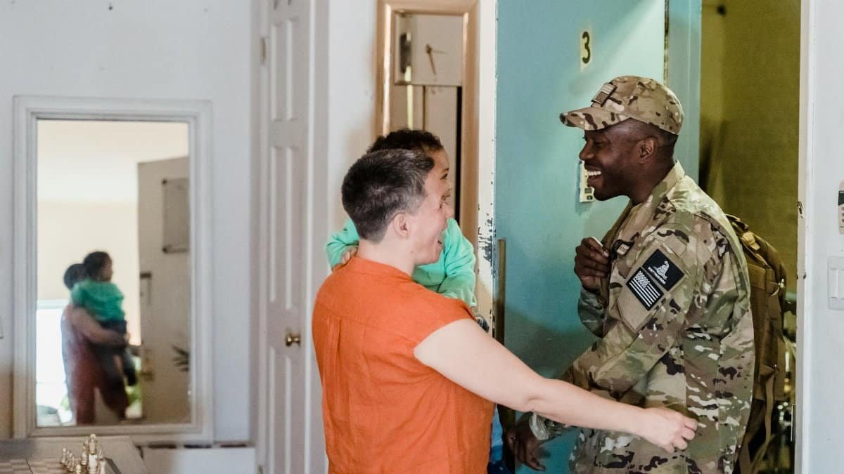 Heartwarming moment of a military family reunion as a soldier returns home.