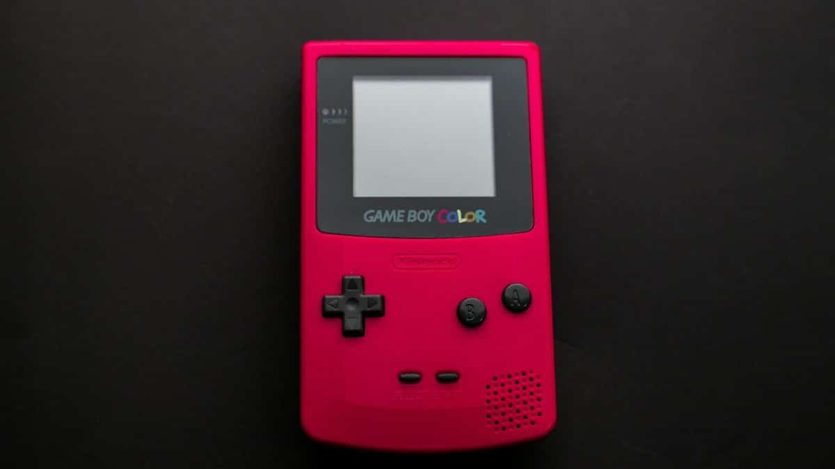 Close-up of a red Nintendo Game Boy Color on a dark backdrop, showcasing retro gaming nostalgia.