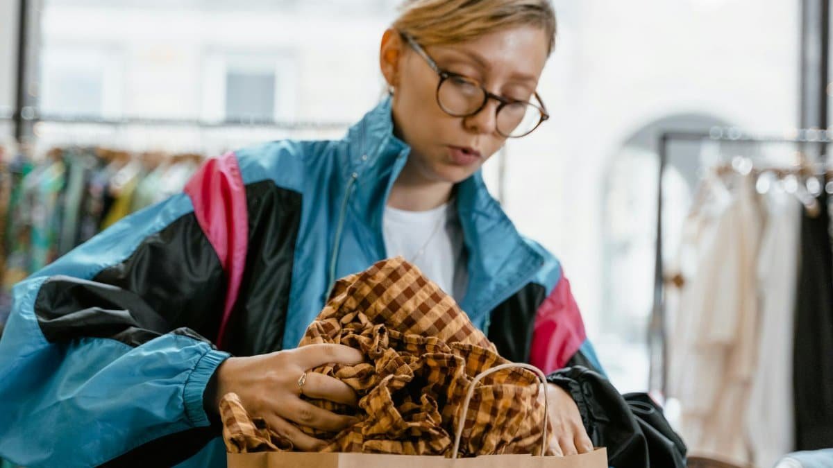 Caucasian woman in a colorful jacket shopping in a trendy boutique.