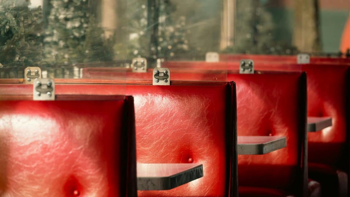 Red leather diner booths with retro charm, evoking vintage vibes and nostalgia.
