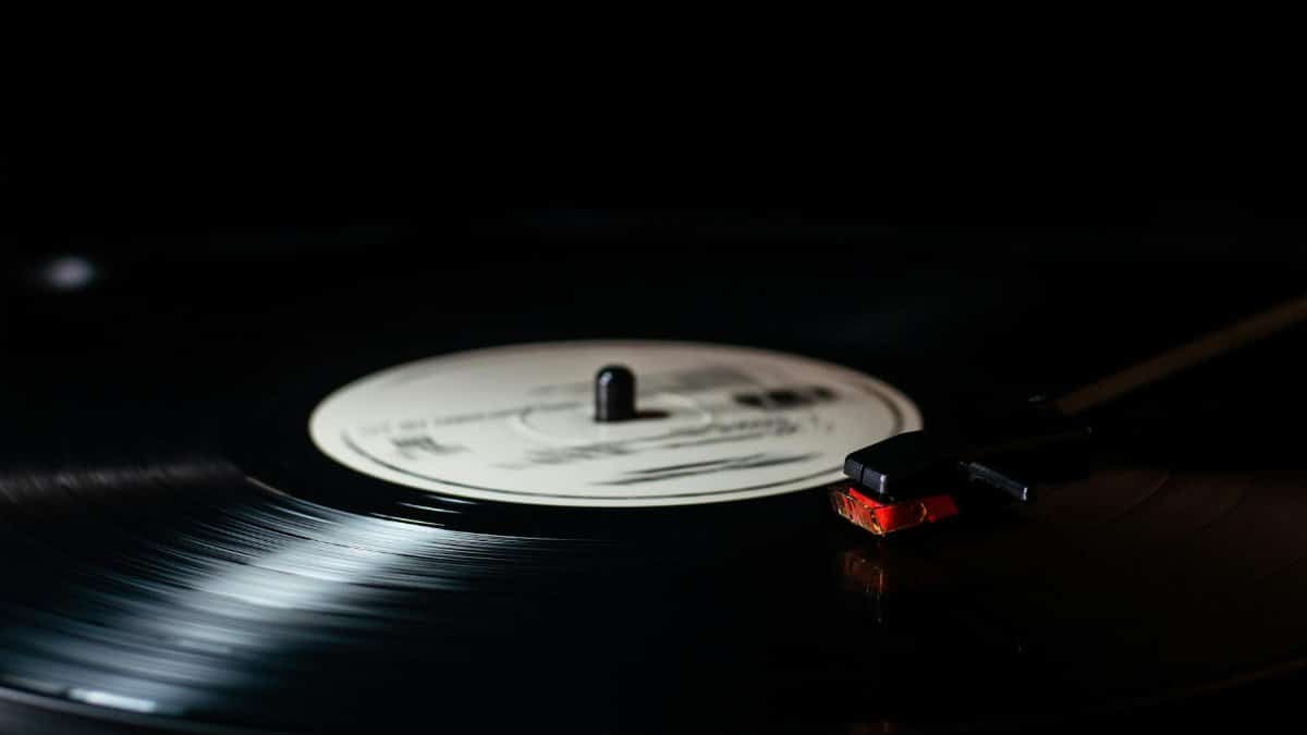 Vintage vinyl record on turntable with stylus close-up, perfect for music lovers.