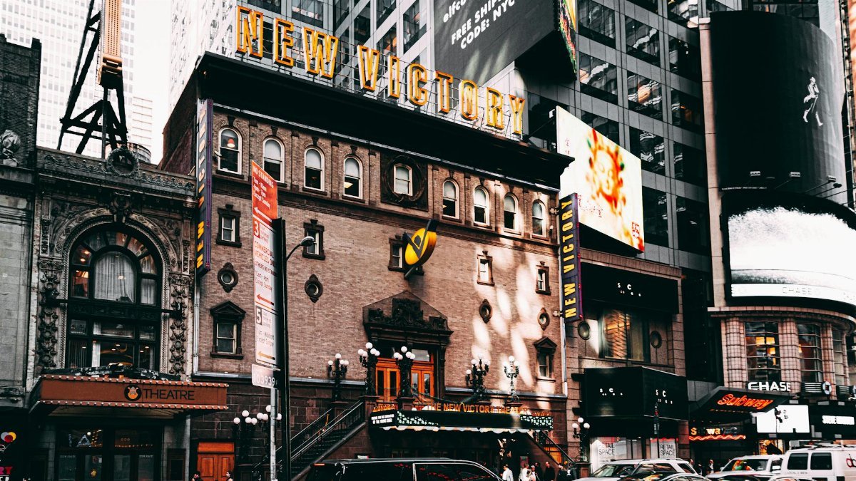 Captivating view of New Victory Theater amid bustling Times Square, NYC.