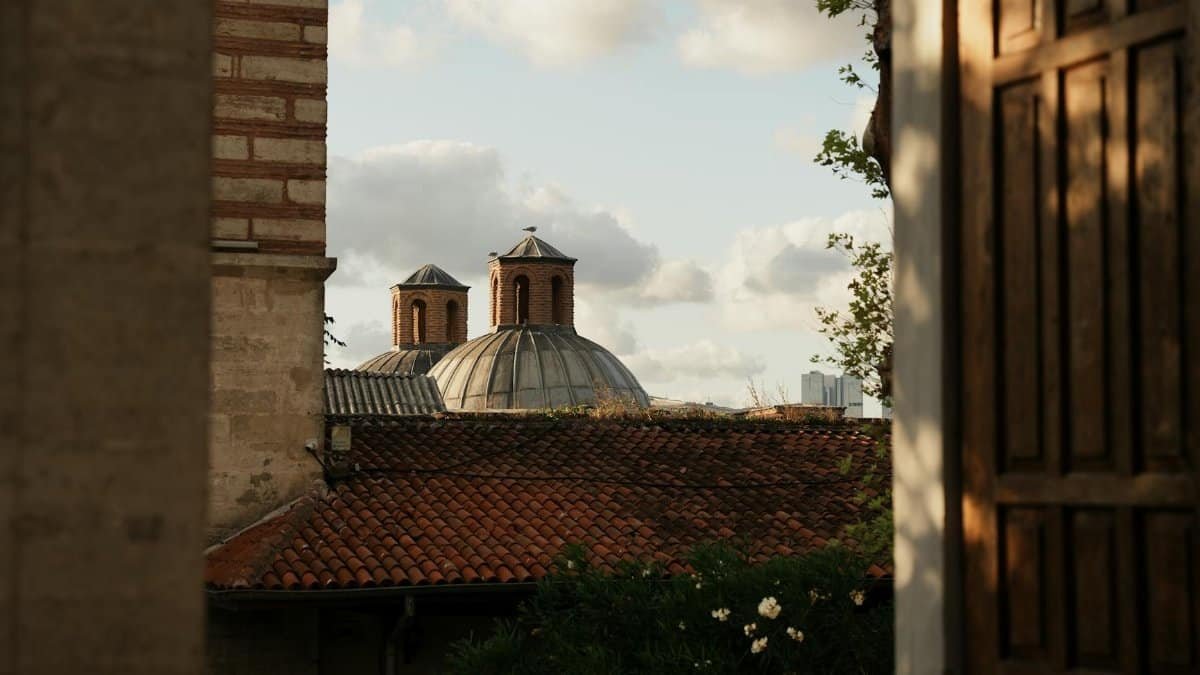A picturesque view of an ancient bathhouse with domes against a cloudy sky in Bursa, Turkey.