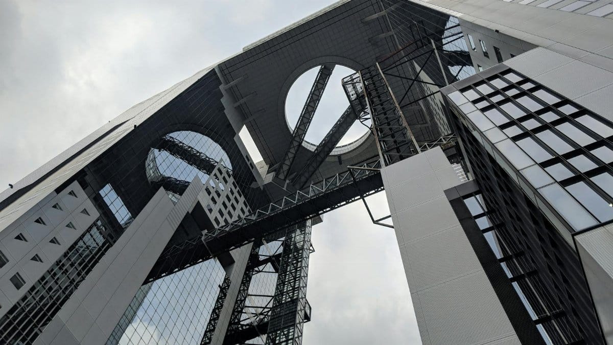 Low angle view of the innovative Umeda Sky Building, showcasing modern architecture in Osaka, Japan.