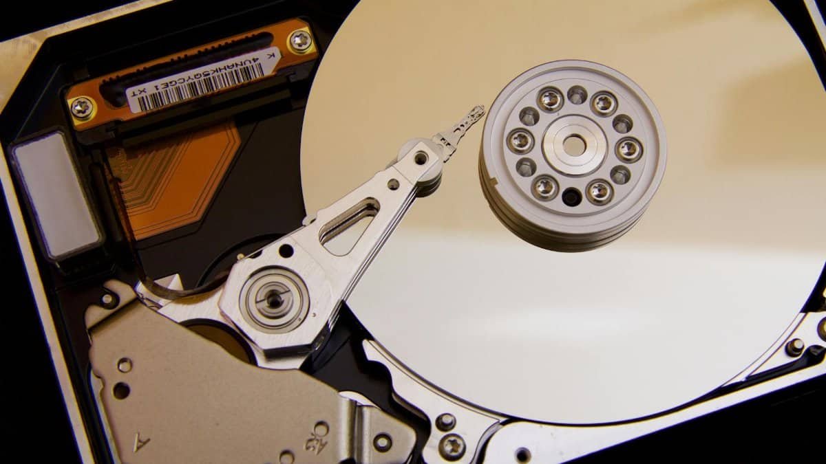 Detailed close-up of a hard disk drive showing the actuator arm and data platters.