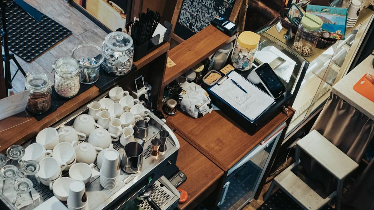 Overhead view of a café in Krasnodar, showcasing coffee cups, cash register, and cozy atmosphere.