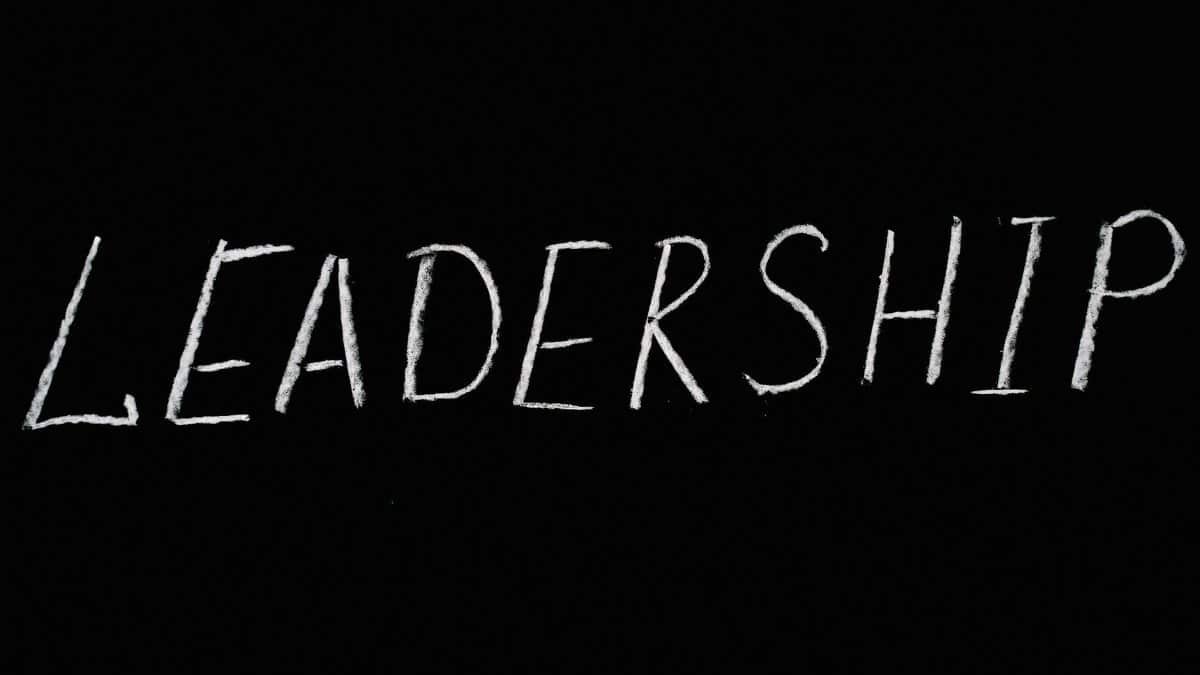Chalk text spelling 'Leadership' on a blackboard, symbolizing guidance and authority.