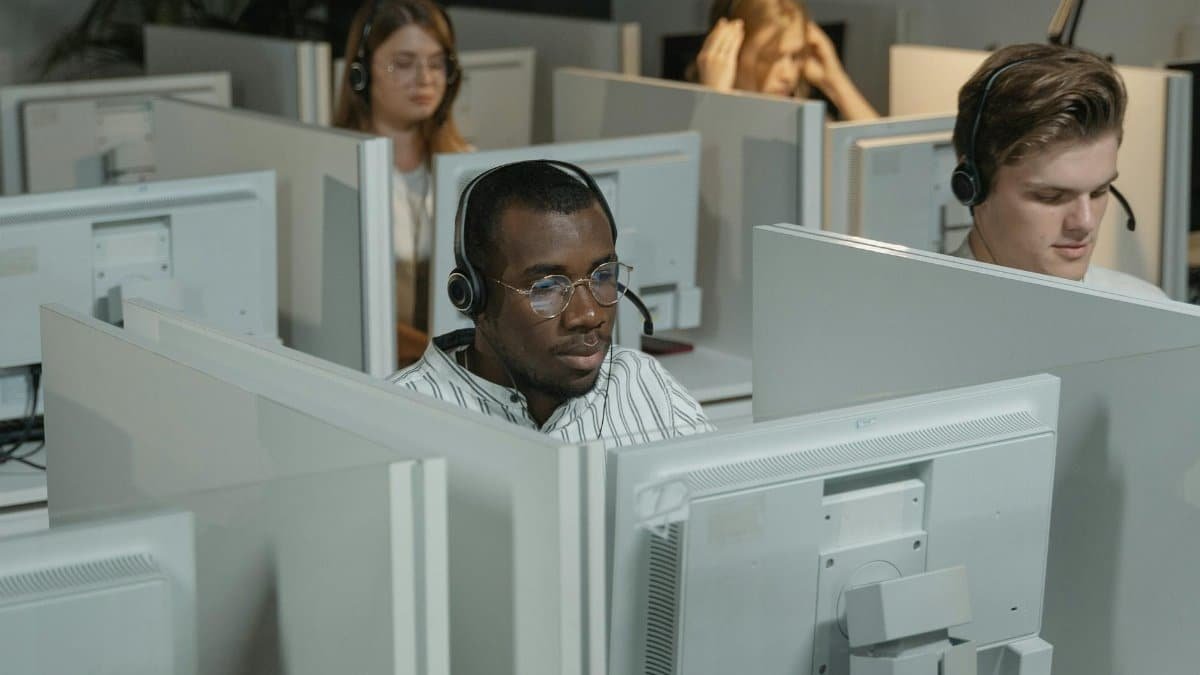 Focused call center agents working in an office environment, providing customer support.