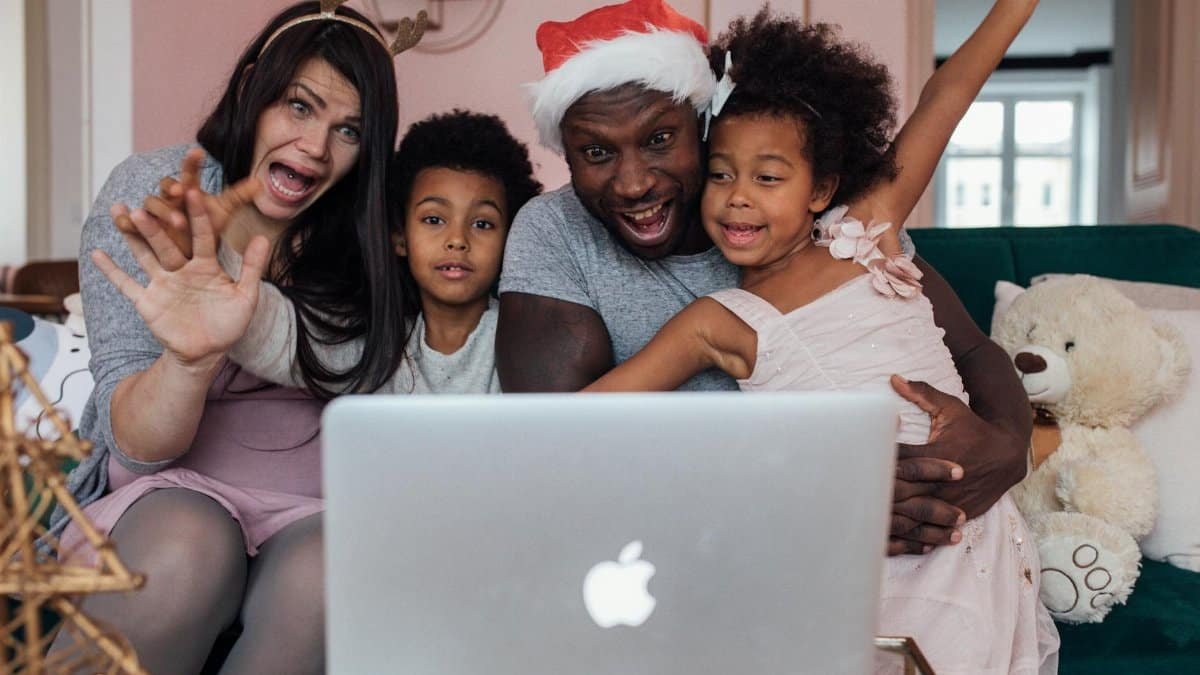 Joyful family enjoying Christmas together with a video call, spreading love and happiness.