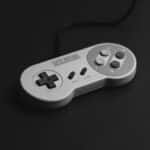 Close-up of a vintage Super Nintendo controller on a black background.