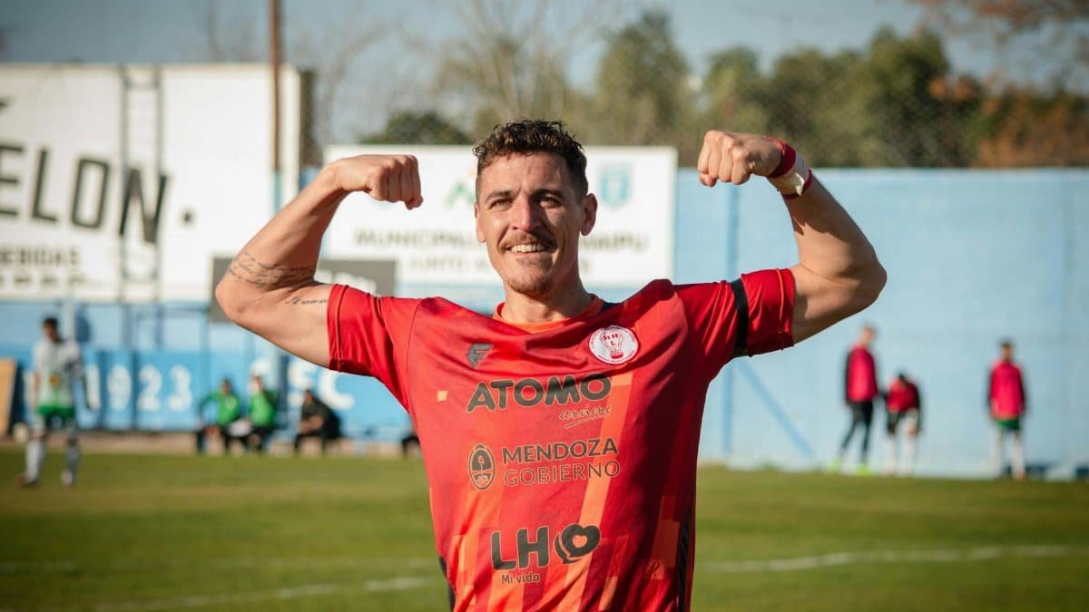Smiling football player flexing muscles in Mendoza, Argentina.