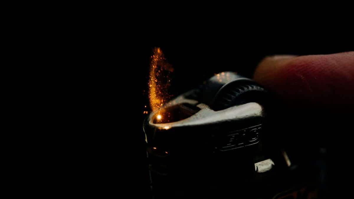 Close-up of a Bic lighter igniting with sparks against a dark background. Captures the essence of fire and ignition.