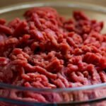 High-quality image of fresh ground beef in a glass bowl, ideal for culinary and food-related themes.