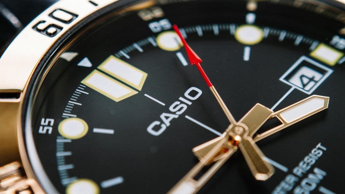 Detailed shot of a classic analog wristwatch face highlighting precision and design.