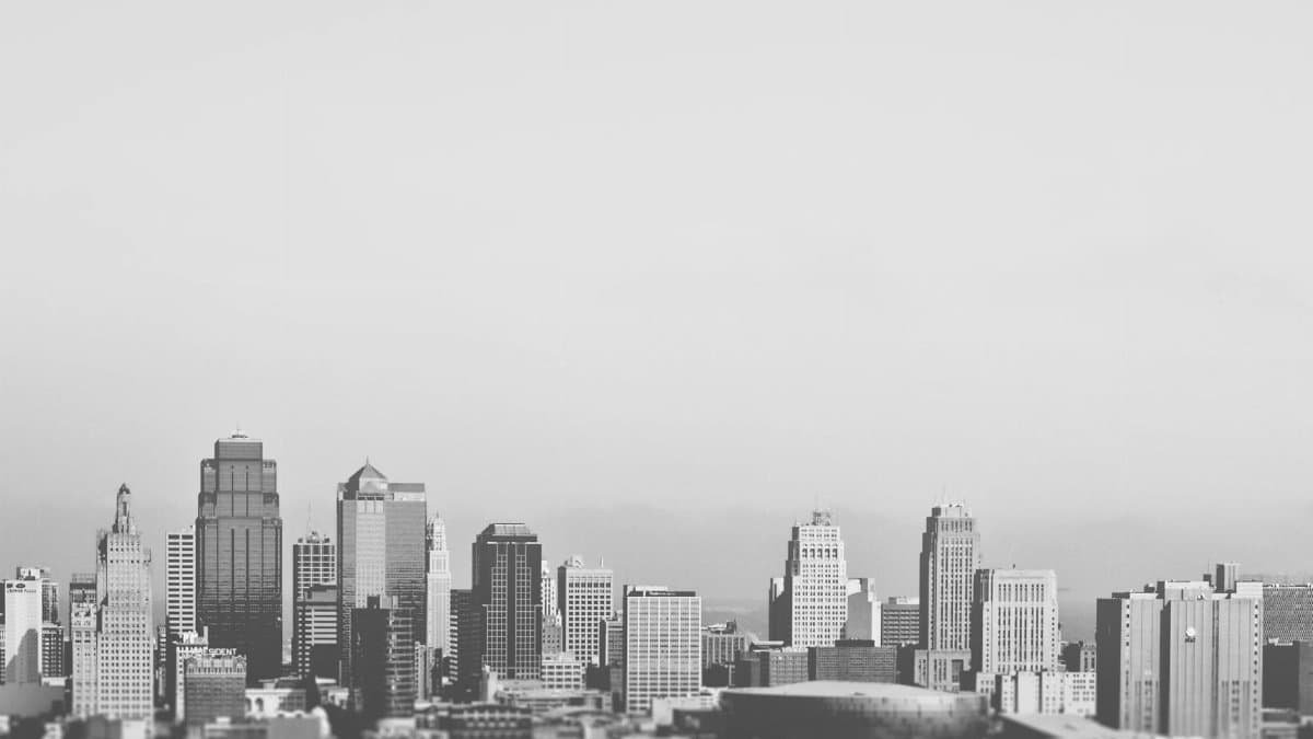 Black and white city skyline showcasing tall buildings and skyscrapers in a geometric layout.