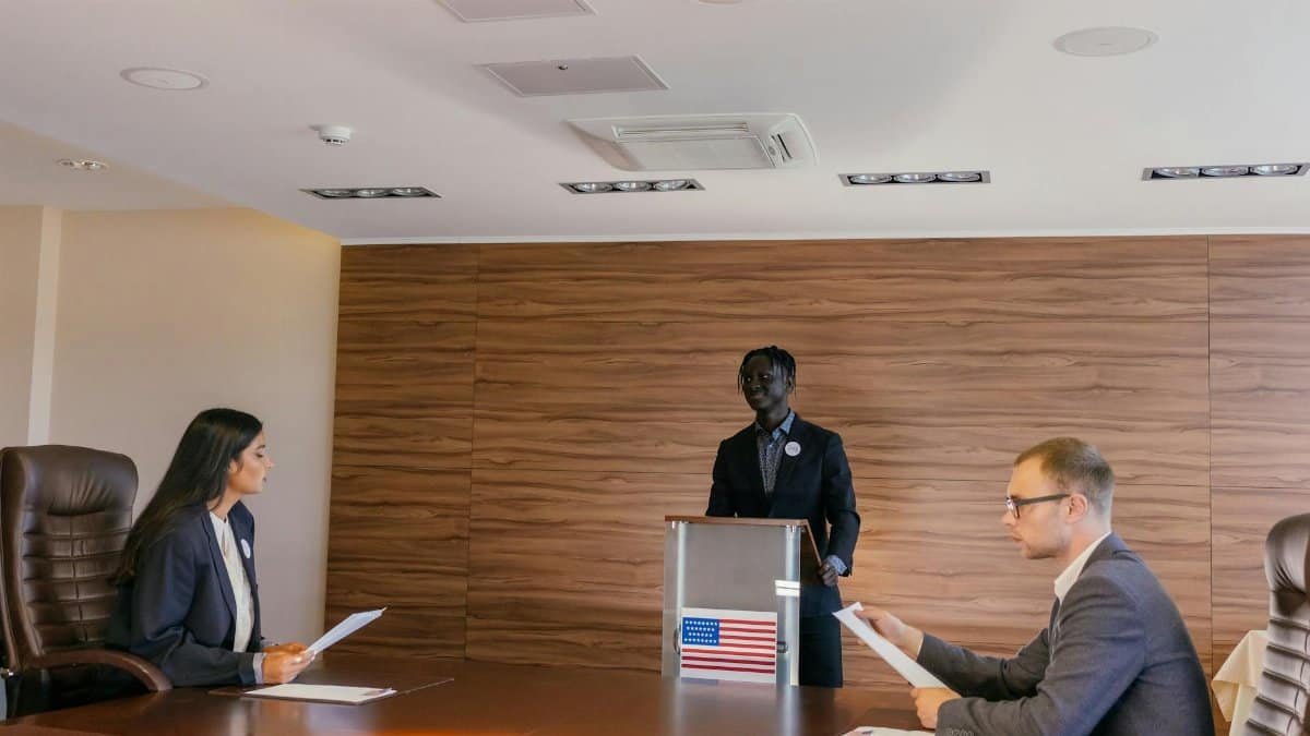 Business professionals engaged in a formal meeting, discussing key topics around a conference table.