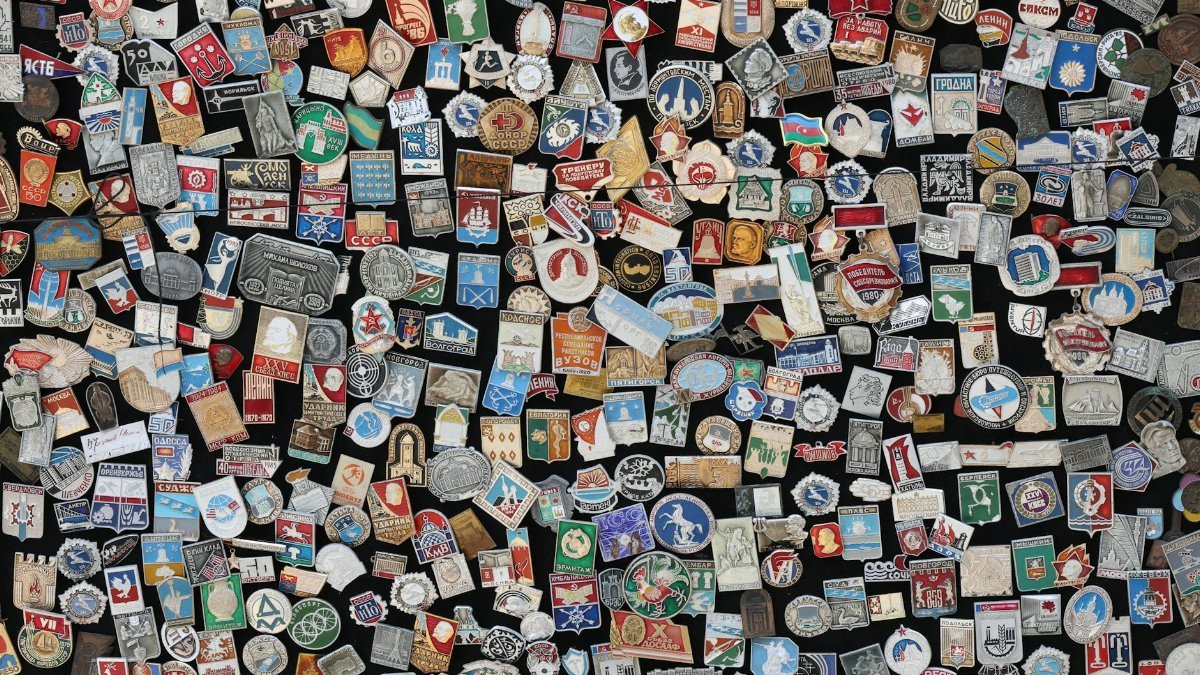 Colorful array of vintage Soviet-era badges and pins on display, showcasing diverse designs and symbols.