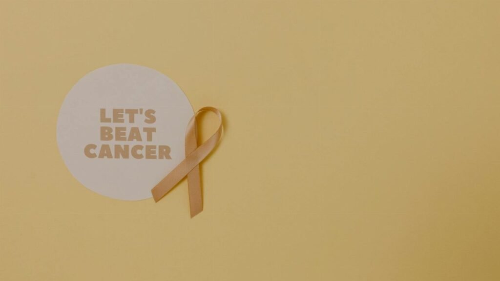 Minimalist design featuring a ribbon and 'Let's Beat Cancer' message for cancer awareness.