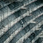 Detailed view of scaffolding on a massive construction site with workers.