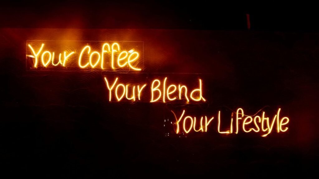 Glowing neon sign saying 'Your Coffee, Your Blend, Your Lifestyle' in warm tones, perfect for cafes.