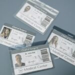 High-angle view of medical ID badges for chief surgeons on a gray surface.