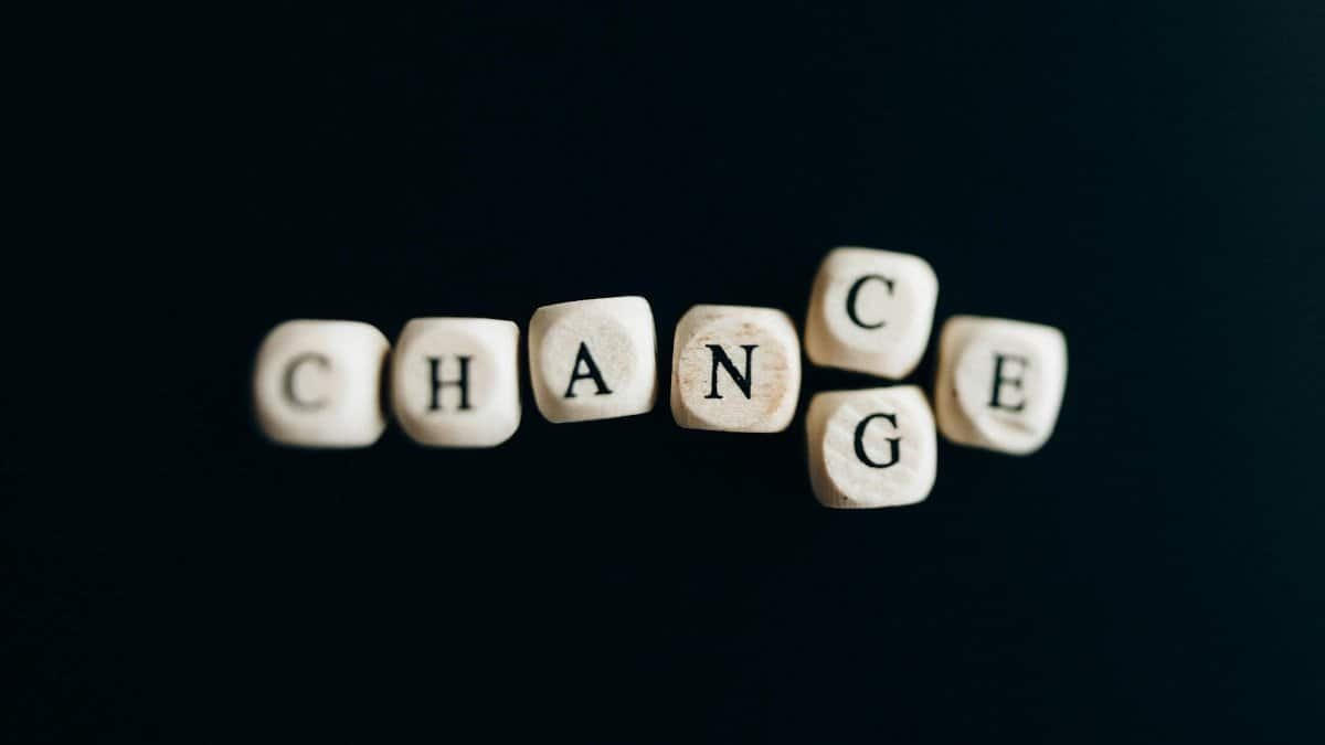 Letter dice forming the word 'Change' on a dark background, symbolizing transformation and opportunity.