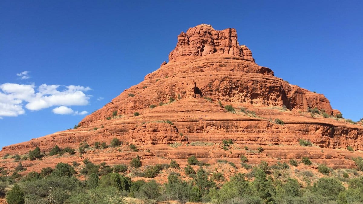 Vibrant view of Bell Rock under a clear blue sky in Sedona, Arizona.