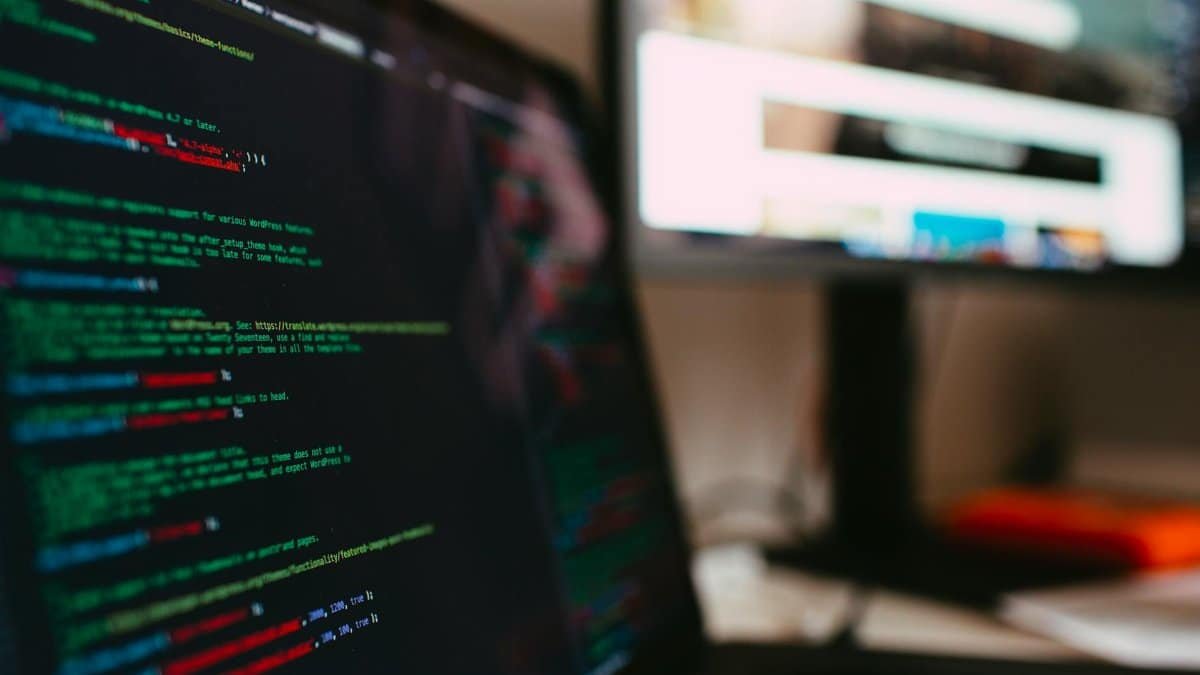 A detailed view of programming code displayed on a laptop screen, depicting a tech workspace.