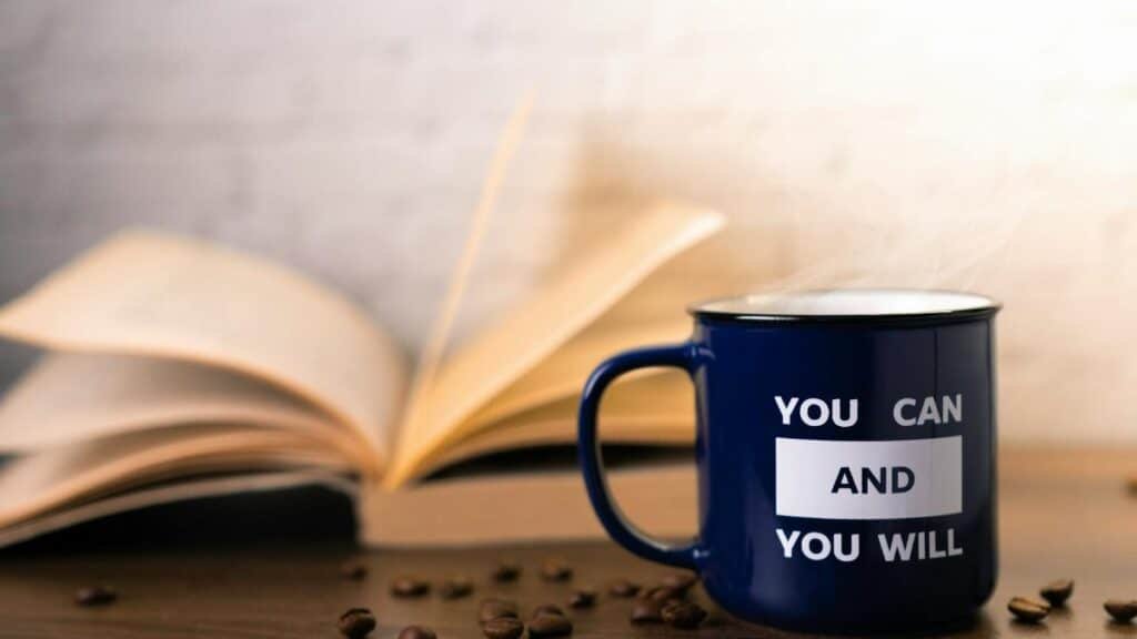 Motivational mug with an open book and coffee beans, perfect for inspiring your day.