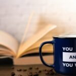 Motivational mug with an open book and coffee beans, perfect for inspiring your day.