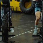 Two people exercising on stationary bikes at a modern gym.