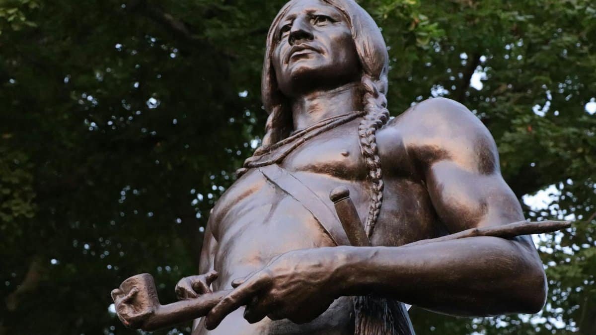 A detailed close-up of the Massasoit statue by Cyrus Edwin Dallin captured from a low angle.