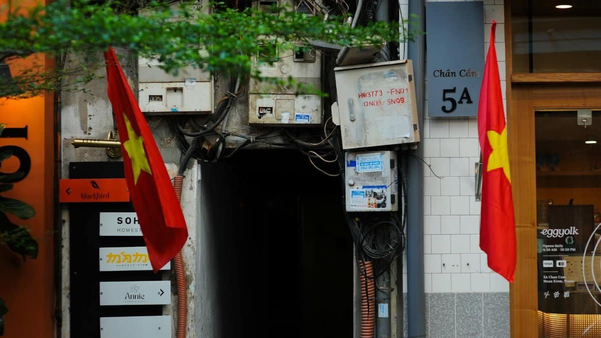 Urban scene featuring Vietnamese flags and local signage, capturing vibrant street life.