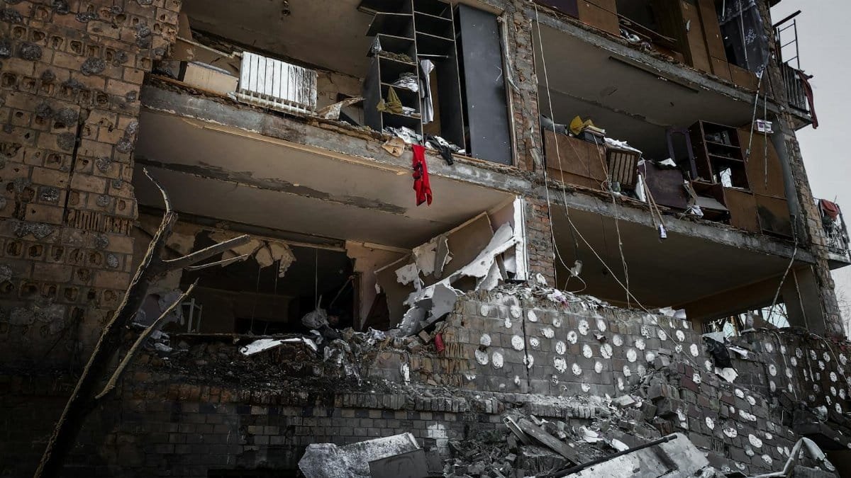 Partially collapsed building facade with structural damage showing interior debris in Kyiv, Ukraine.