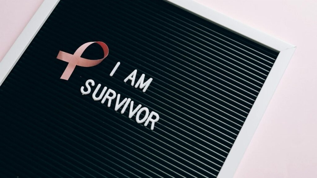 Letter board with pink ribbon symbolizing breast cancer survival.