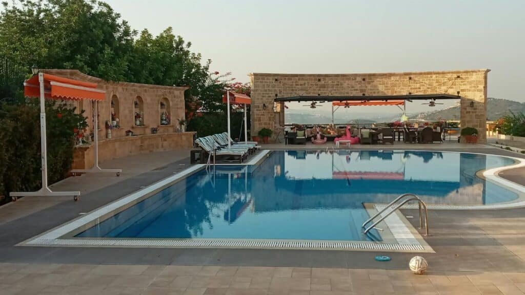 A serene swimming pool at a resort showcasing luxury and relaxation amidst natural surroundings.