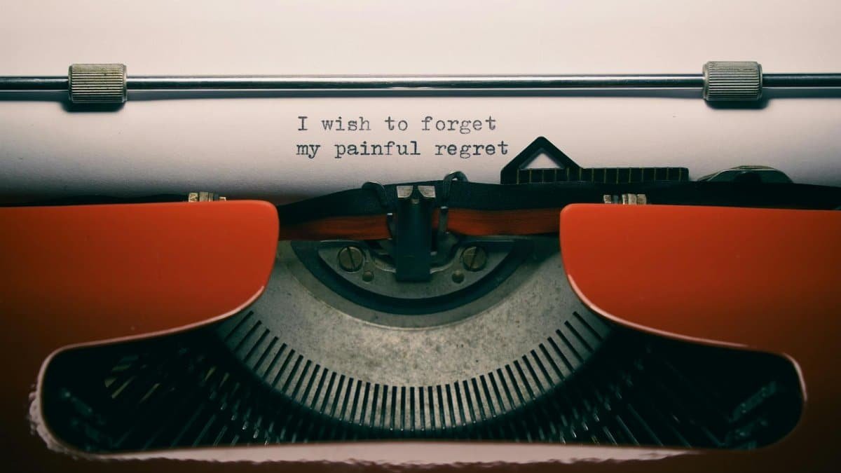 Close-up of a vintage typewriter with melancholic quote, perfect for reflective concepts.