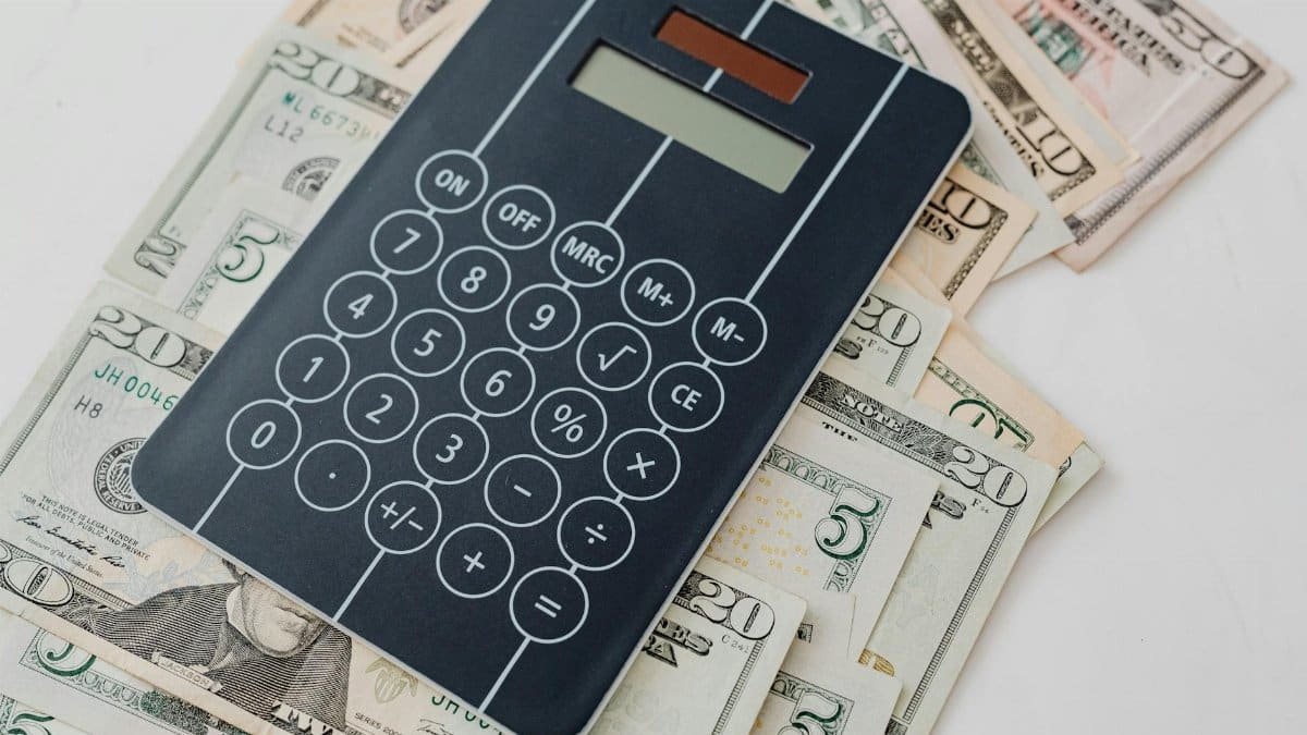 Close-up of a calculator atop US dollar bills, symbolizing financial planning and budgeting.