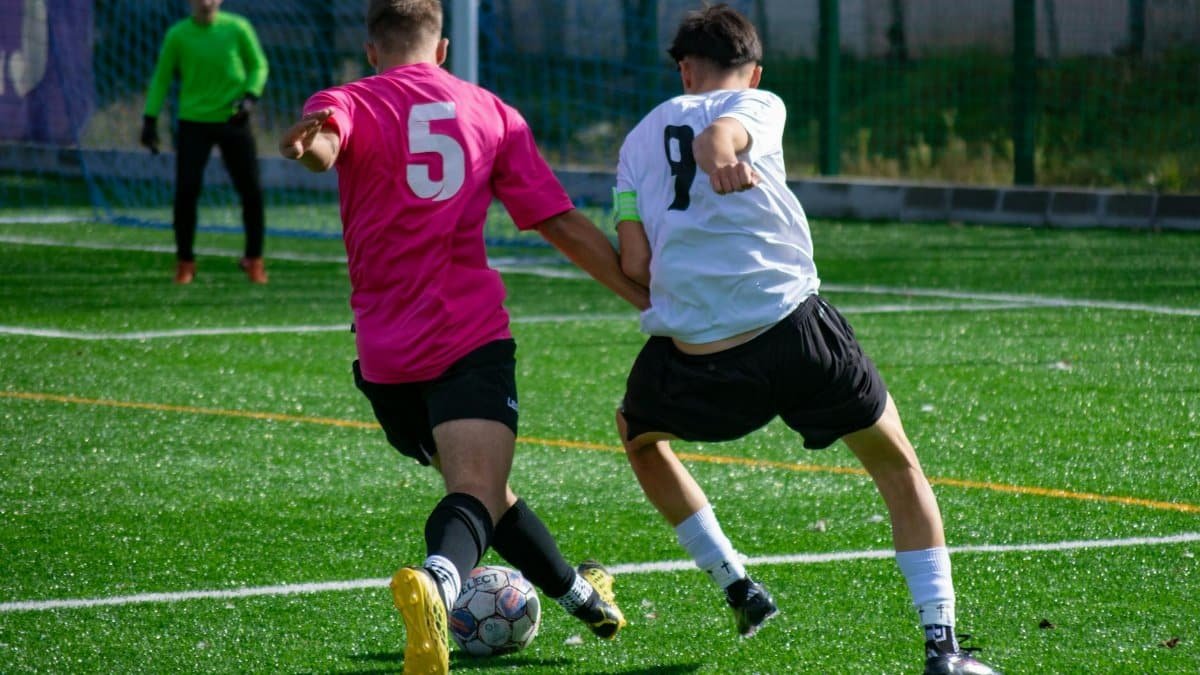 Action-packed soccer match with players competing on a bright, sunny day.