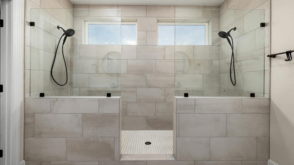 A sleek, contemporary dual shower bathroom featuring elegant tile work and modern fixtures.