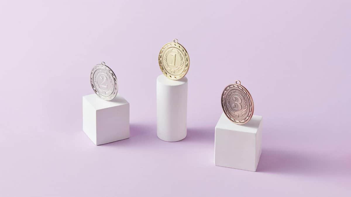 Three medals on podium blocks symbolizing first, second, and third place awards.