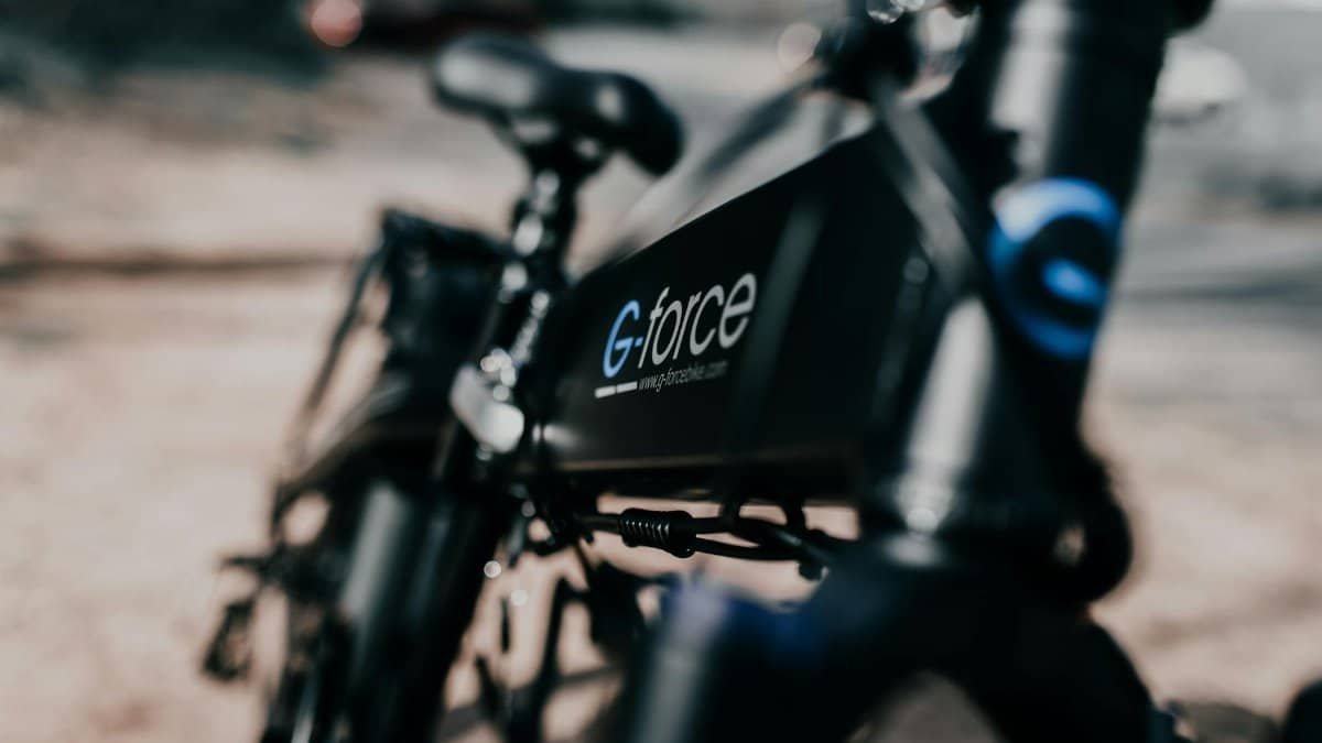 Detailed view of a sleek black electric bike with a blurred background, showcasing modern transportation.