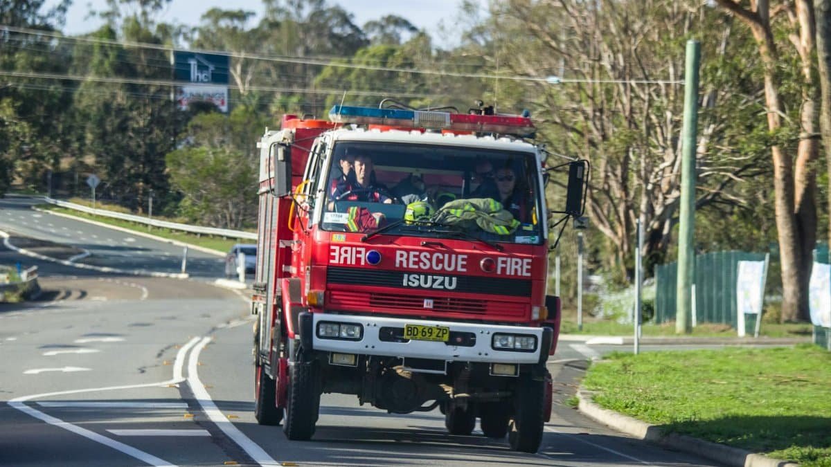 A fire truck rushes on a mission through NSW, Australia, showcasing emergency response.
