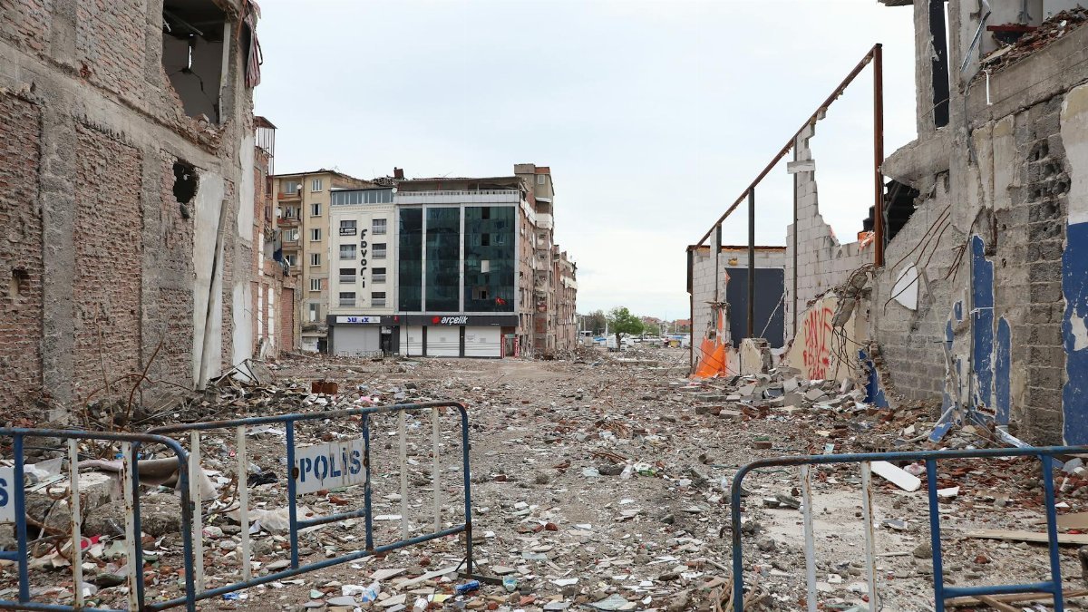 A city street filled with rubble after a natural disaster, showcasing urban devastation.