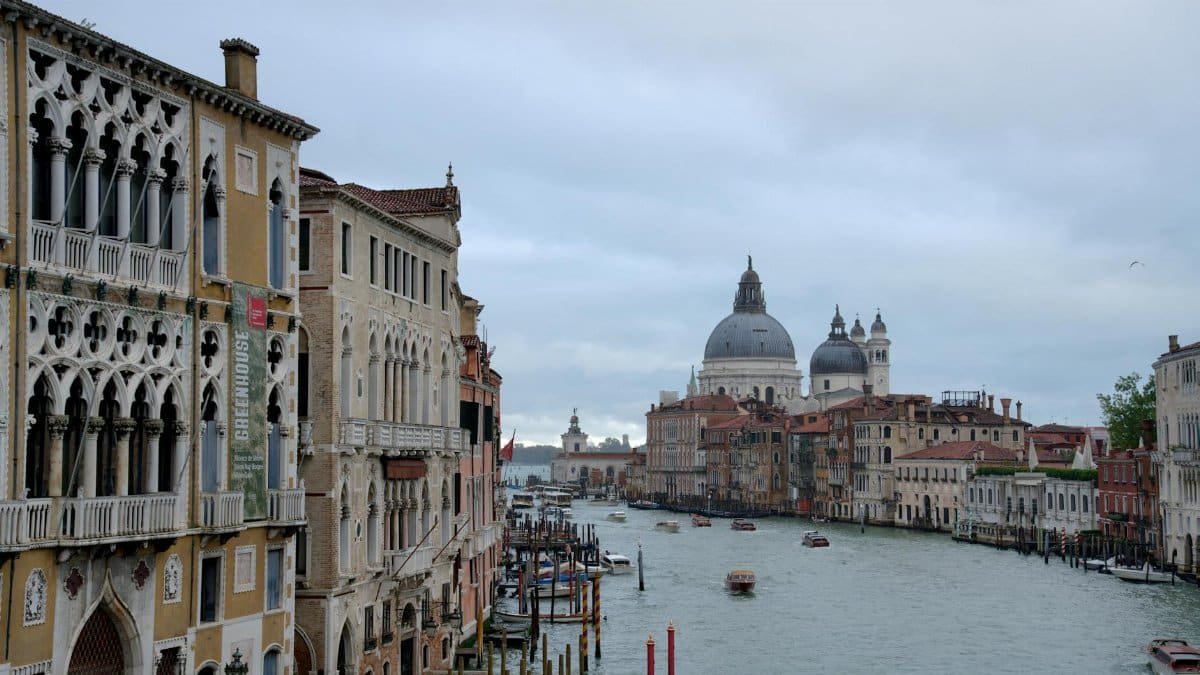 Beautiful view of Venice's Grand Canal with historic architecture on a cloudy day.