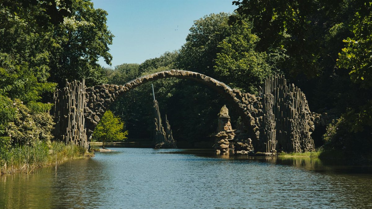 Explore the stunning Rakotzbrücke, known as Devil's Bridge, in Kromlau Park, Germany.