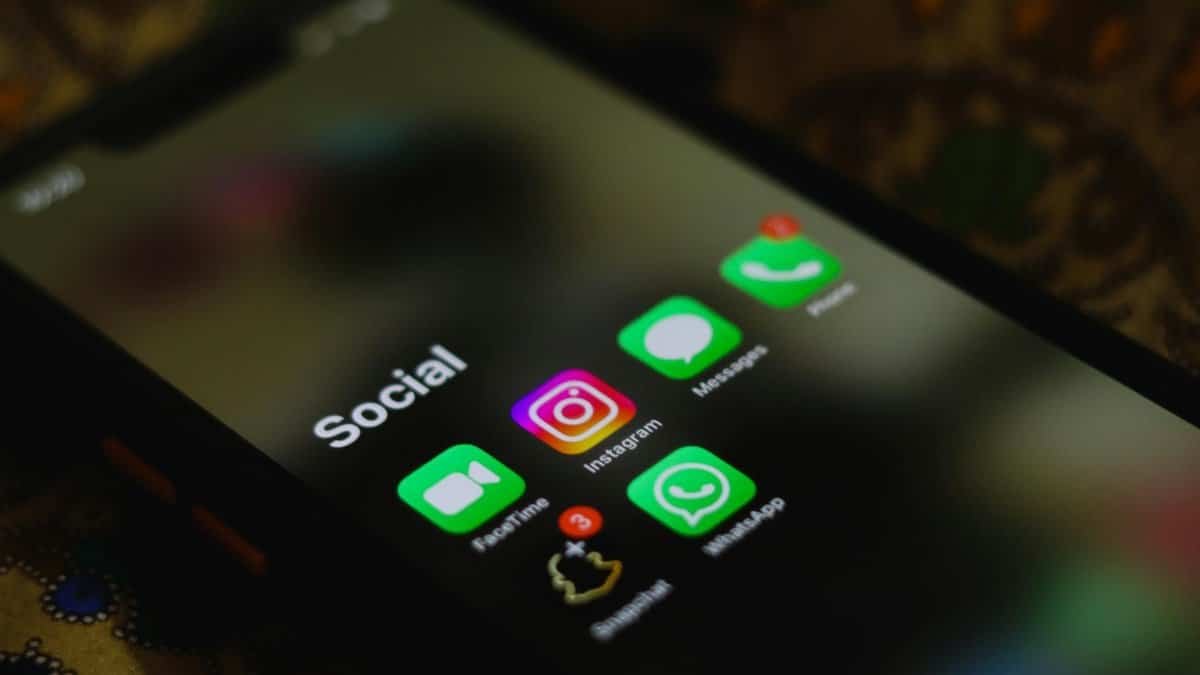 A close-up shot of smartphone displaying social media apps icons on screen.