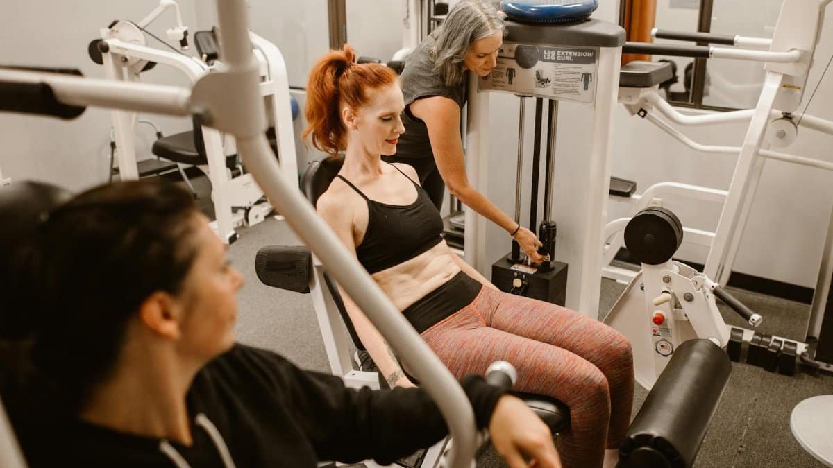 Women working out on gym equipment, promoting strength and fitness.