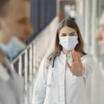 Doctors in masks demonstrating healthcare safety and teamwork indoors.