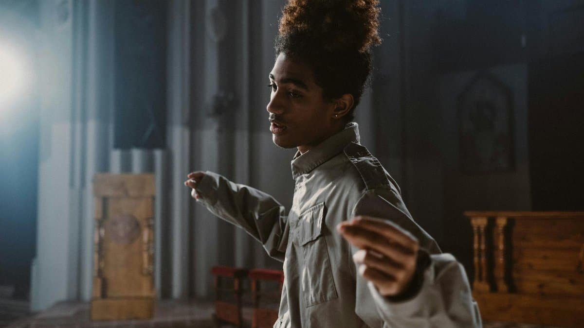 A young man passionately singing inside a church, with sunlight streaming through the windows.